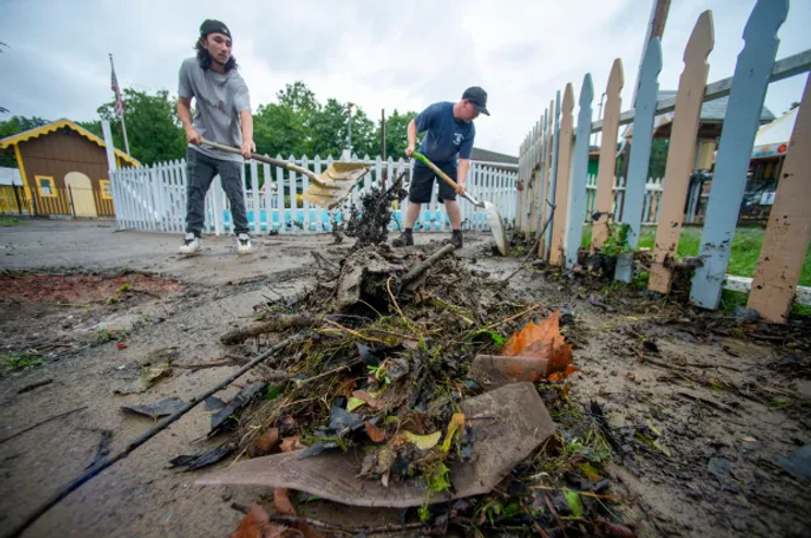 people cleaning a storm drainage